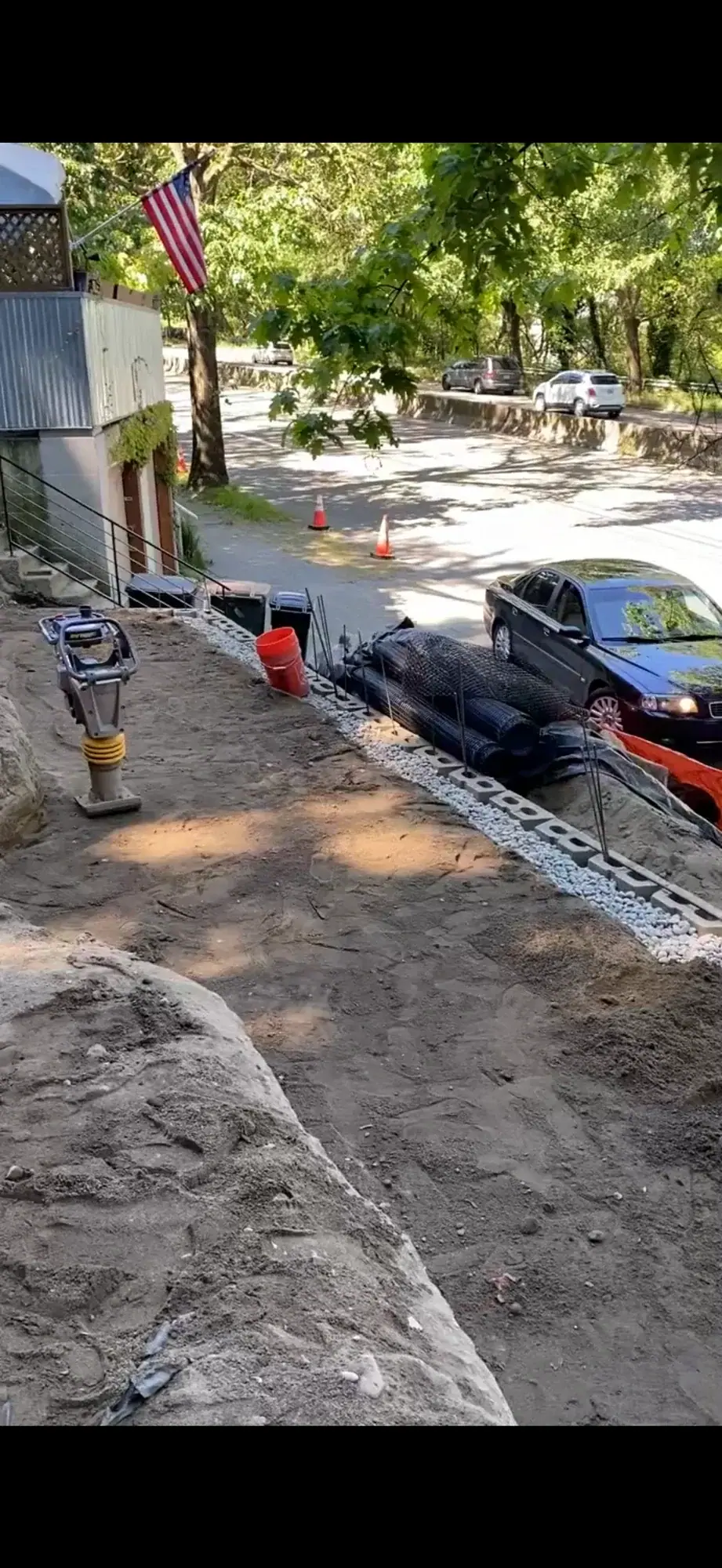 Excavation underway with dump trucks staged on the street