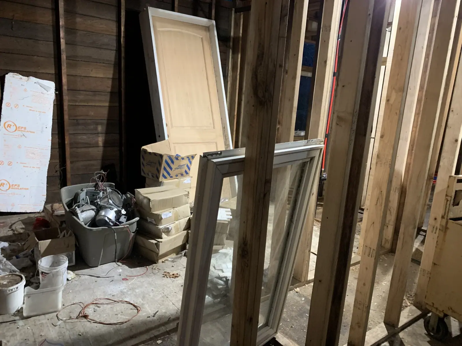 Interior doors stacked in a framed bedroom awaiting drywall