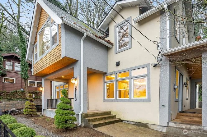 Exterior at twilight with the cedar gable accent and lit windows