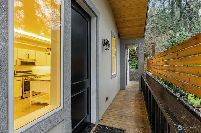 Covered side deck with a cedar ceiling and horizontal slat fence