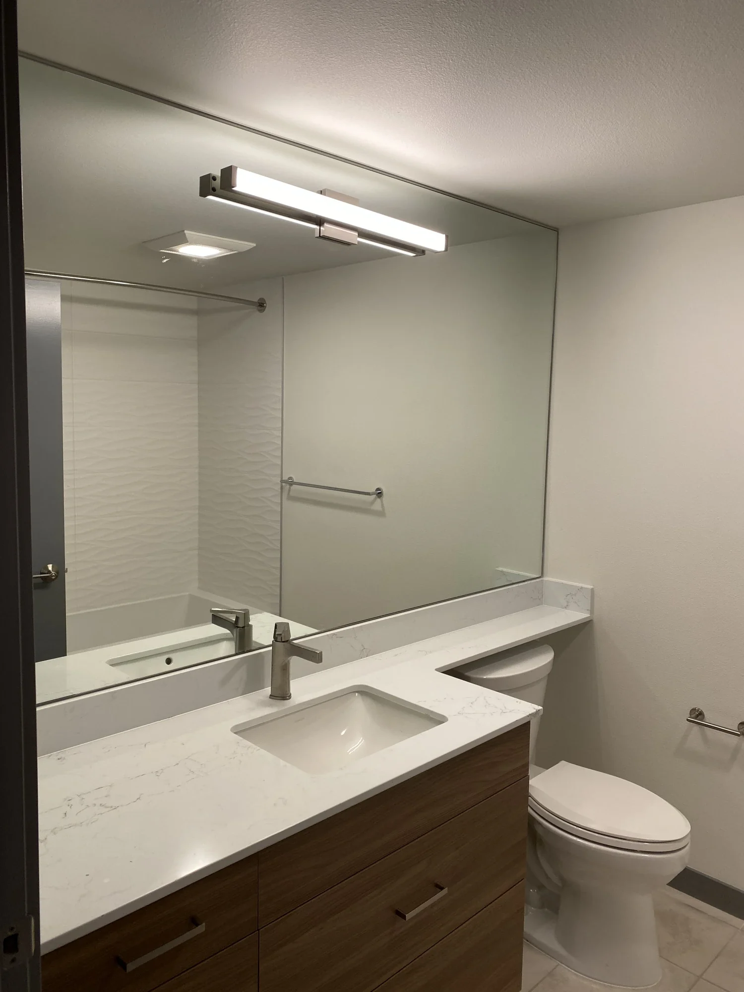 Bathroom with a white vanity, quartz top, and black fixtures