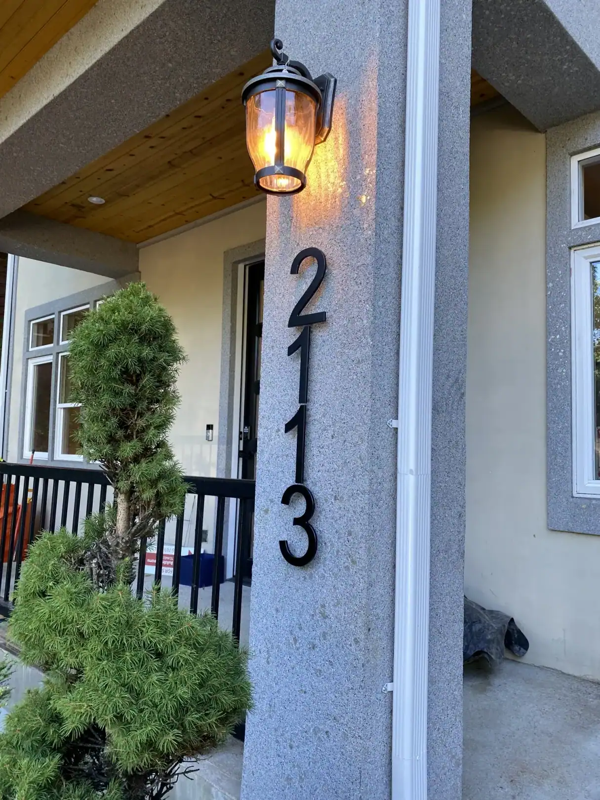 Front entry with the house number and a black lantern light