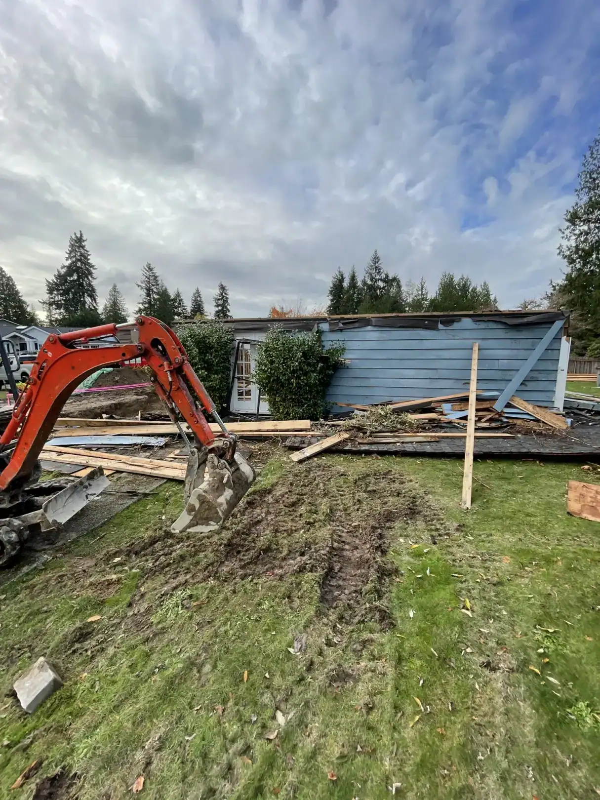 Excavator tearing down the old rambler on the Bellevue lot