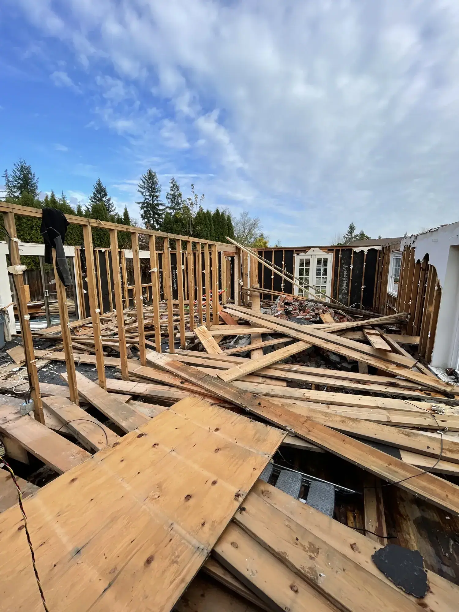Demolition framing and rubble under a blue sky on the Bellevue tear-down