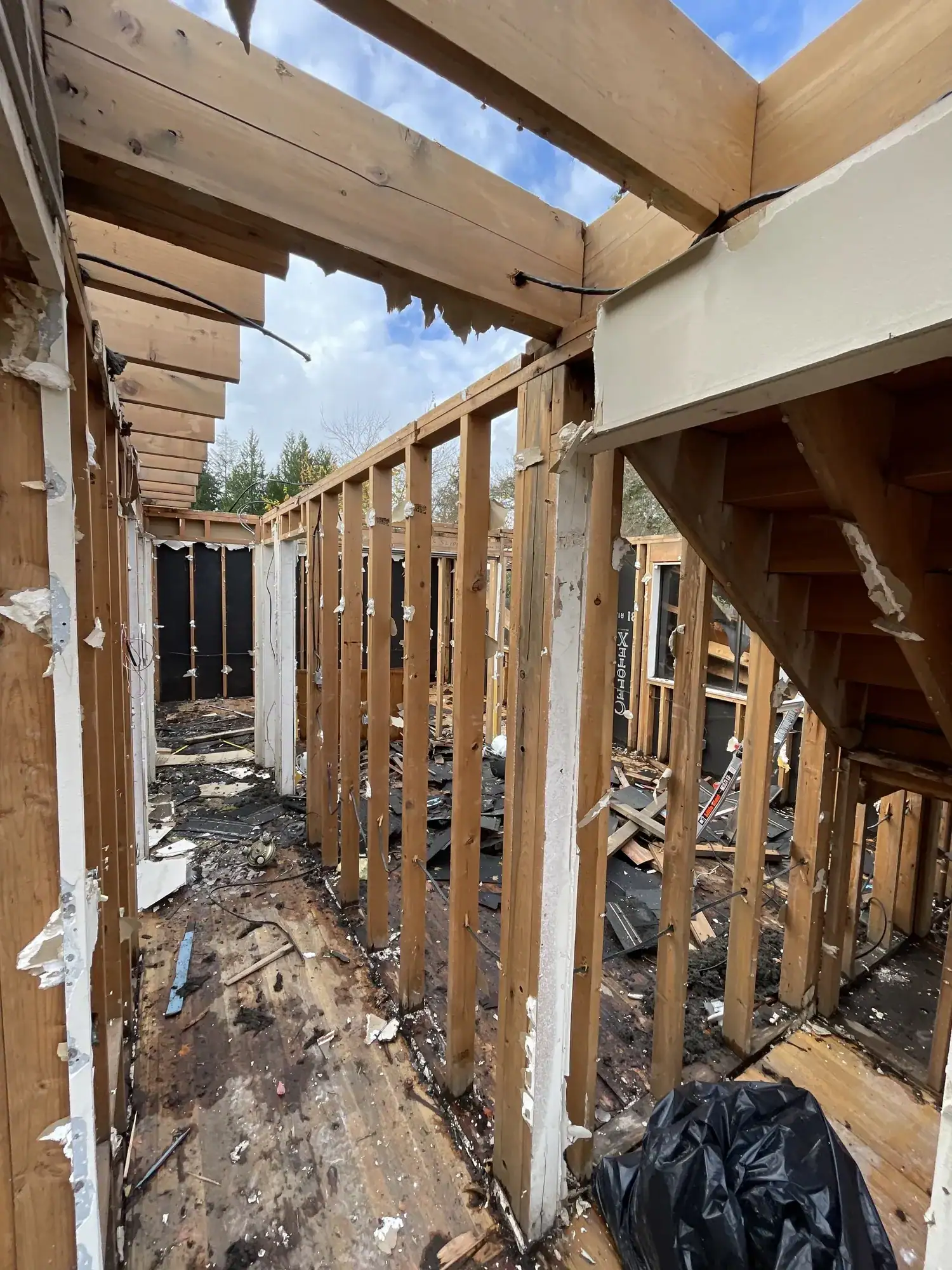 Stripped framing of the old house with the roof opened to the sky