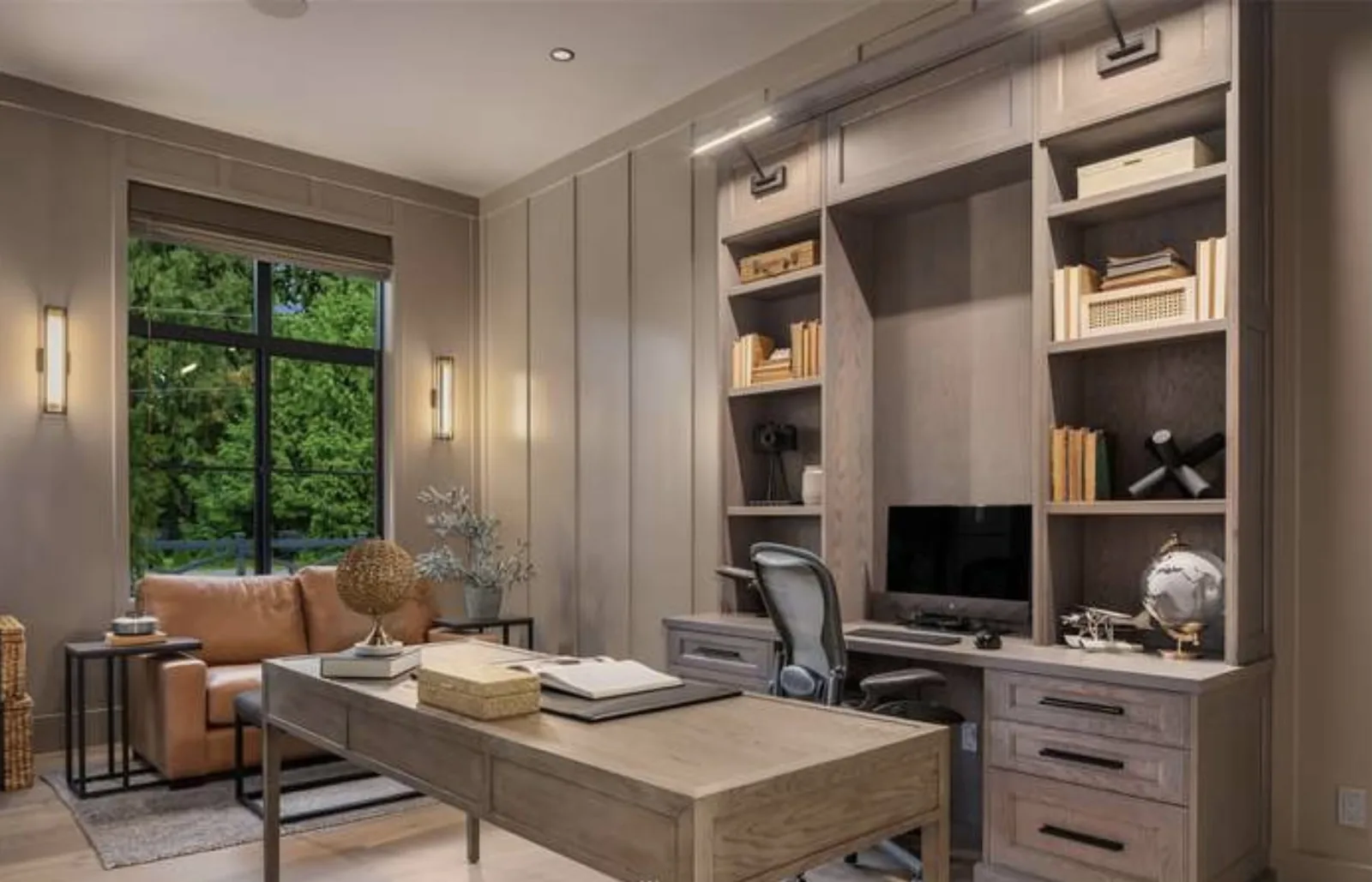 Home office with built-in desk and shelving in warm wood millwork beside a black-frame window