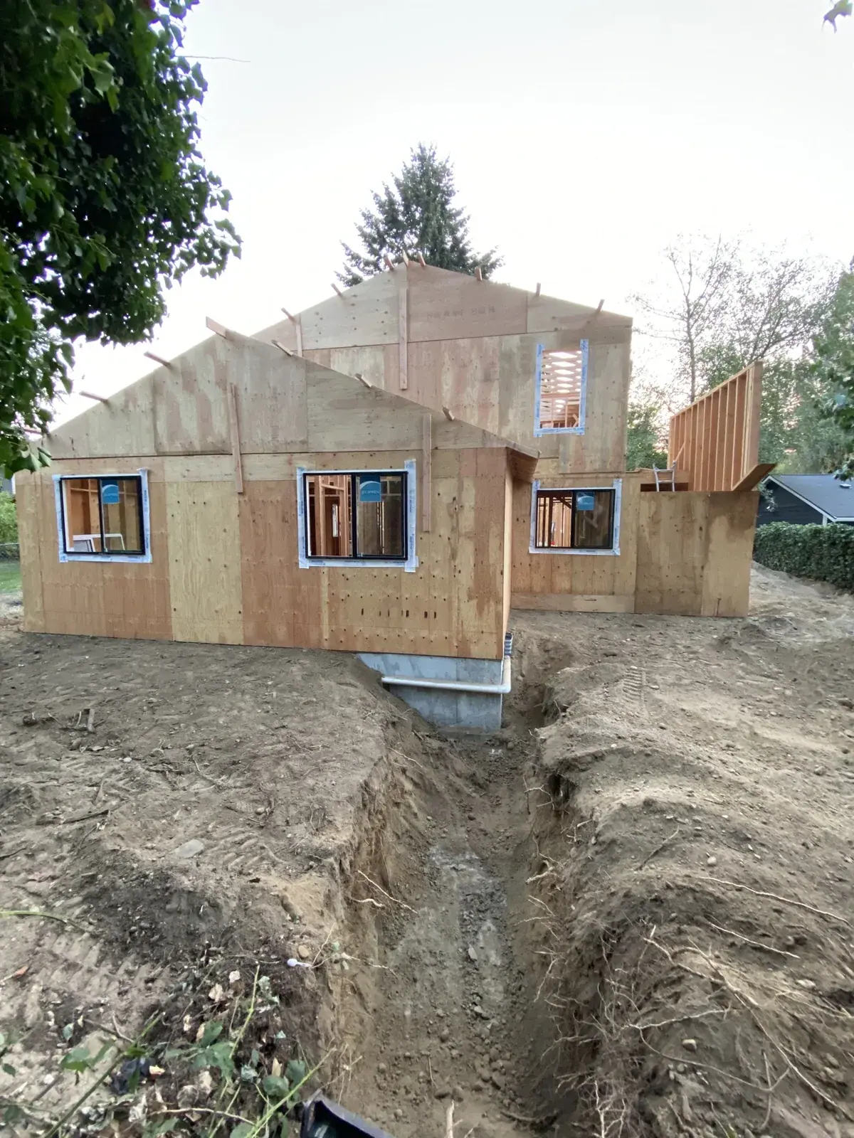 Sheathed exterior above the cut bank and footing trench