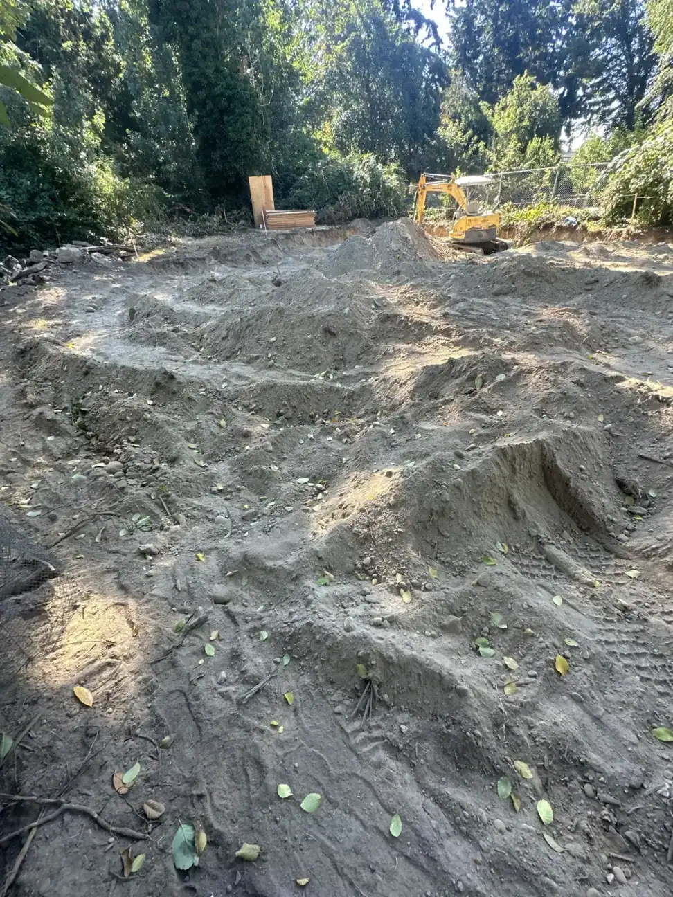 Graded dirt pad after excavation, ready for footings