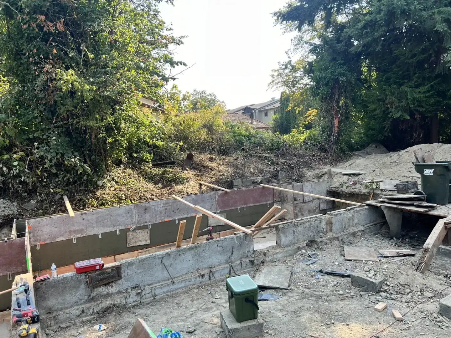 Plywood foundation wall forms with bracing along the cut bank