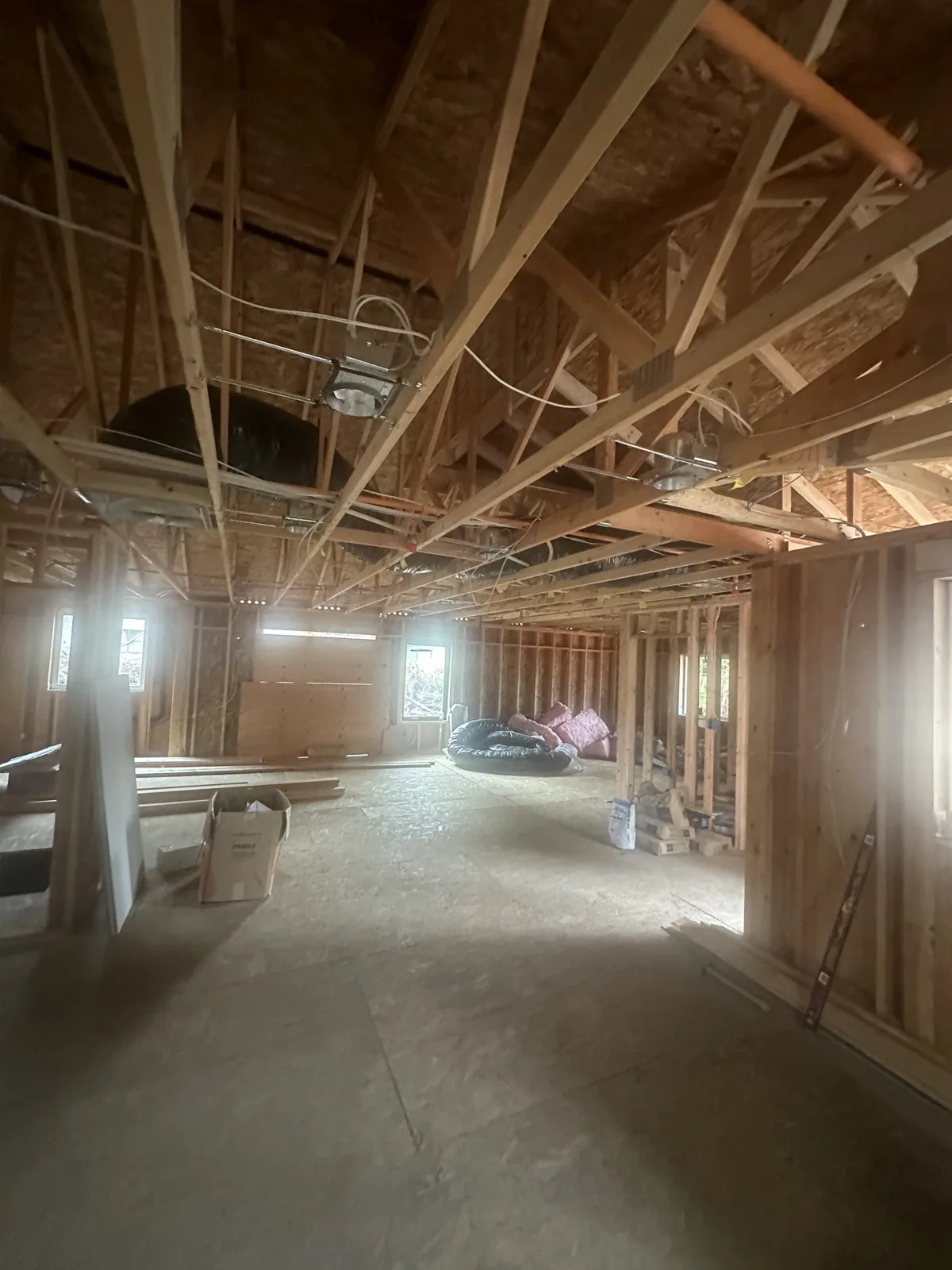 Framed rooms beneath the trusses with window openings cut
