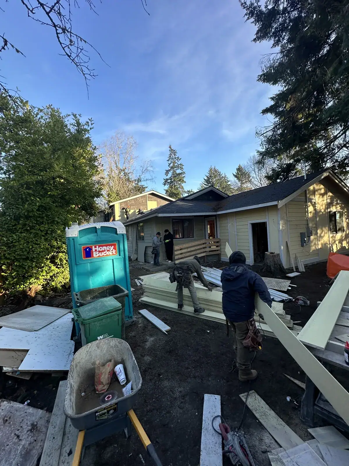 Crew installing fiber-cement siding on the exterior
