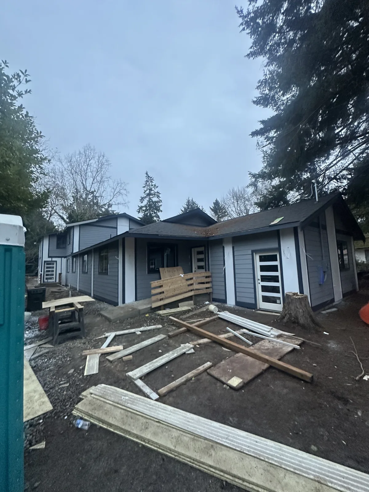 Exterior during trim and paint prep with a portable toilet on site