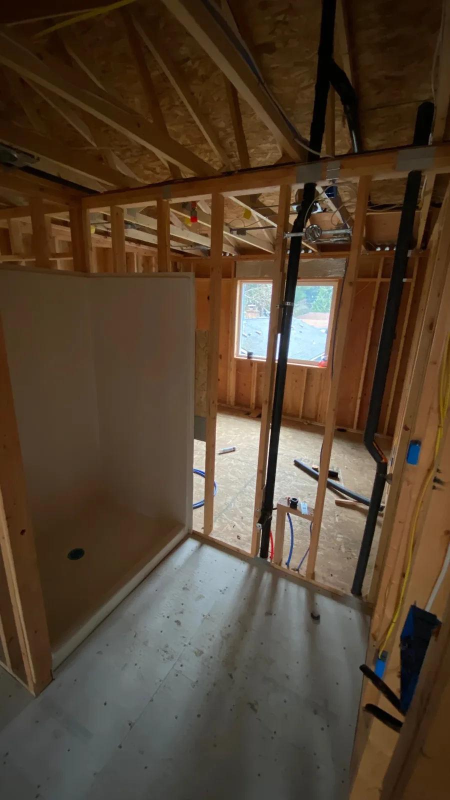 Framed bedroom with a window opening ahead of insulation