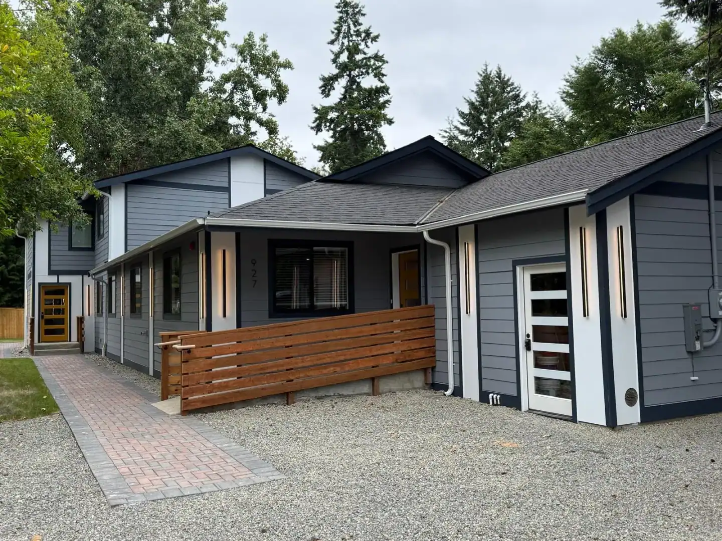 Finished Boise home with a paver walkway, cedar-slat railing, and gravel yard