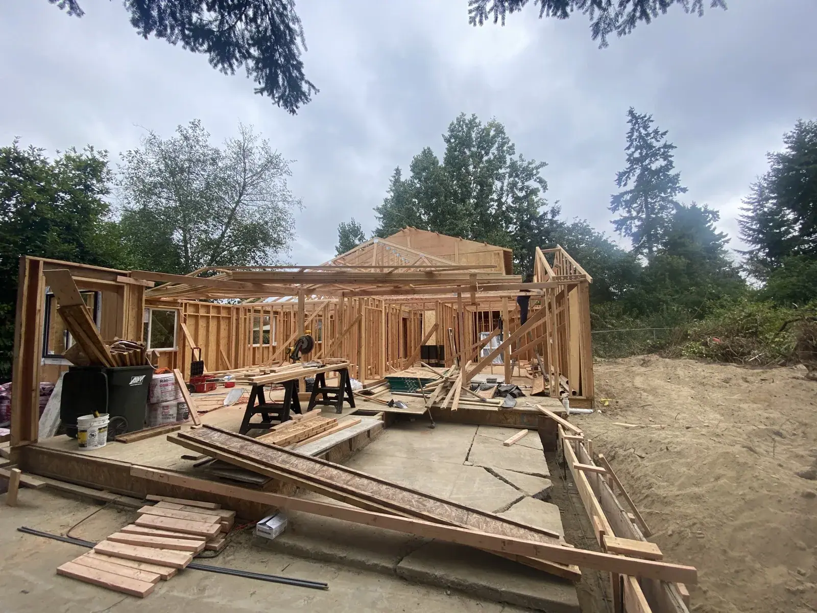 First-floor framing with materials staged across the deck