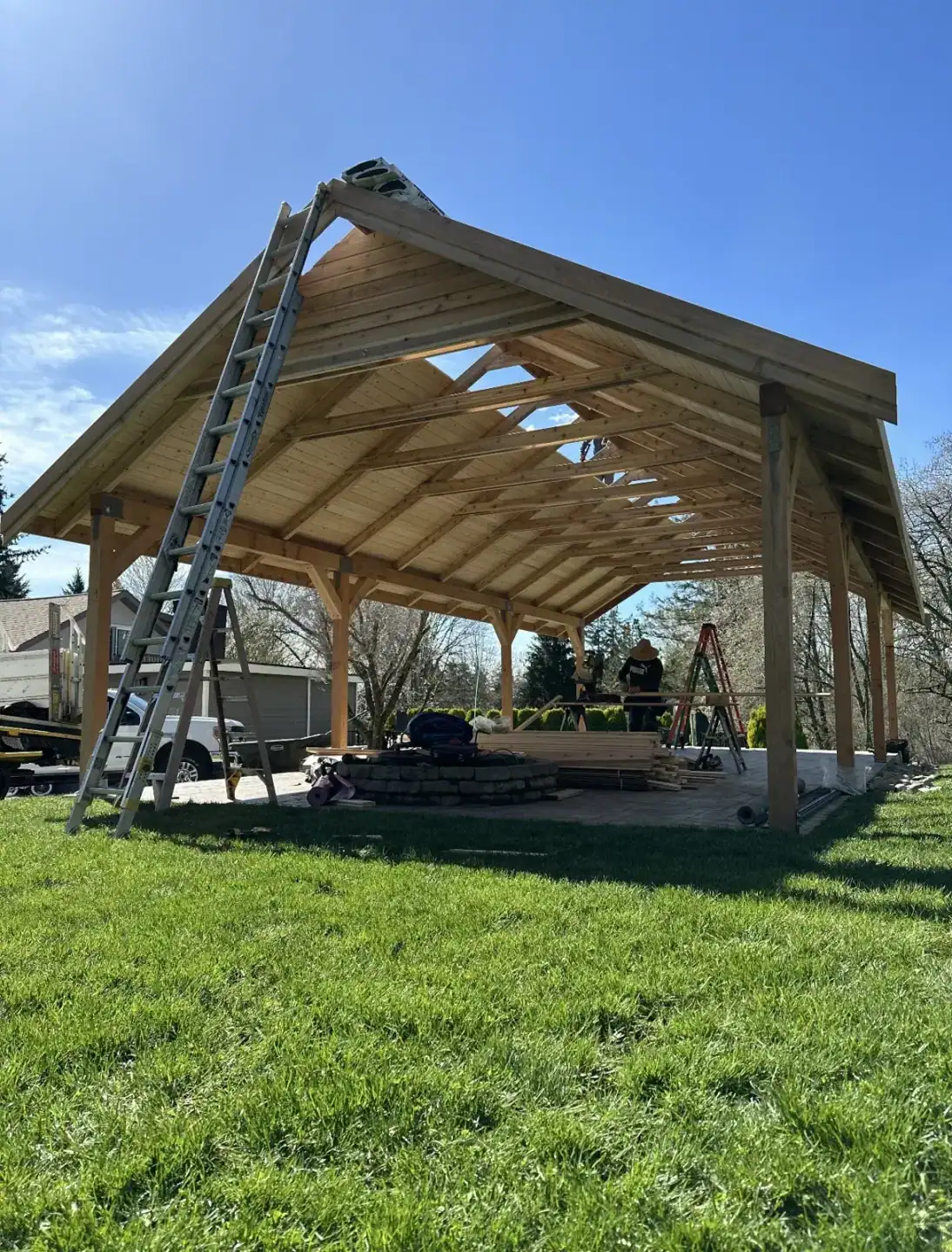 Full truss and rafter frame viewed from outside with a ladder against the eave