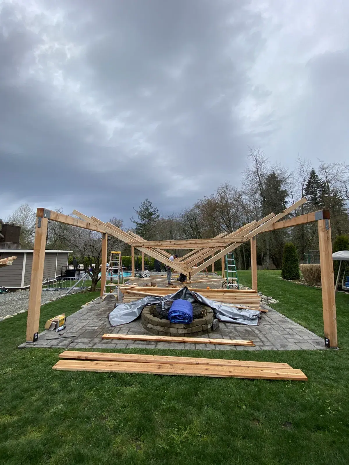 First cedar gable truss and rafters being raised onto the posts