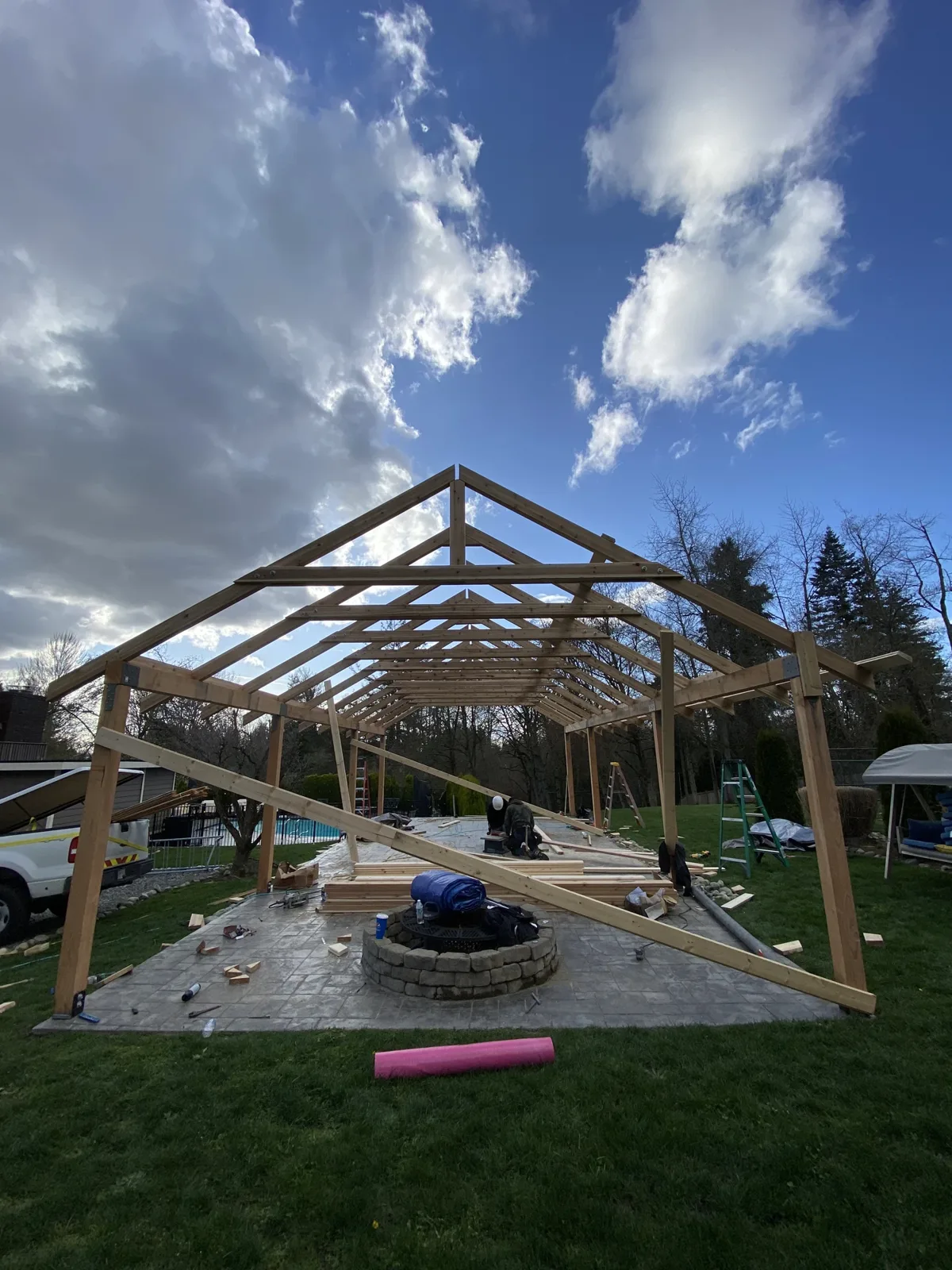 Completed cedar truss frame against a dramatic North Idaho sky