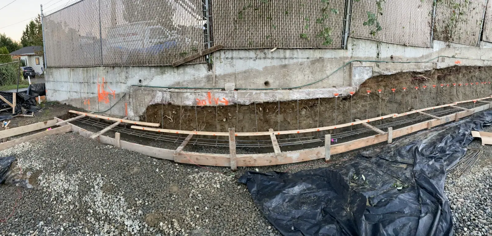 Curved footing form with rebar following the property line on gravel base