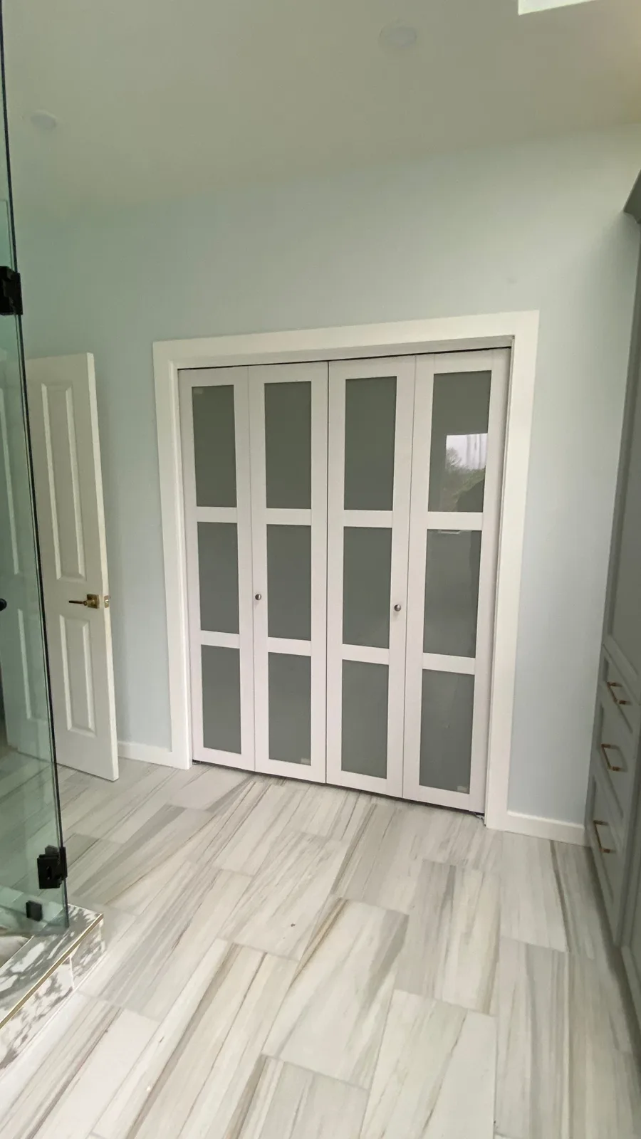 Frosted bifold doors opening to the walk-in closet