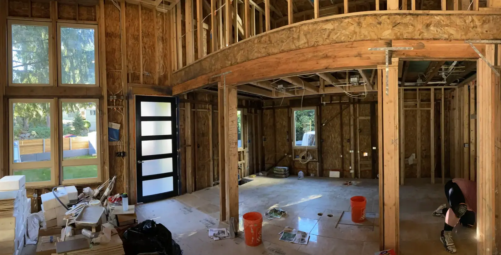 Interior framing showing the curved arch header that opens the kitchen to the great room