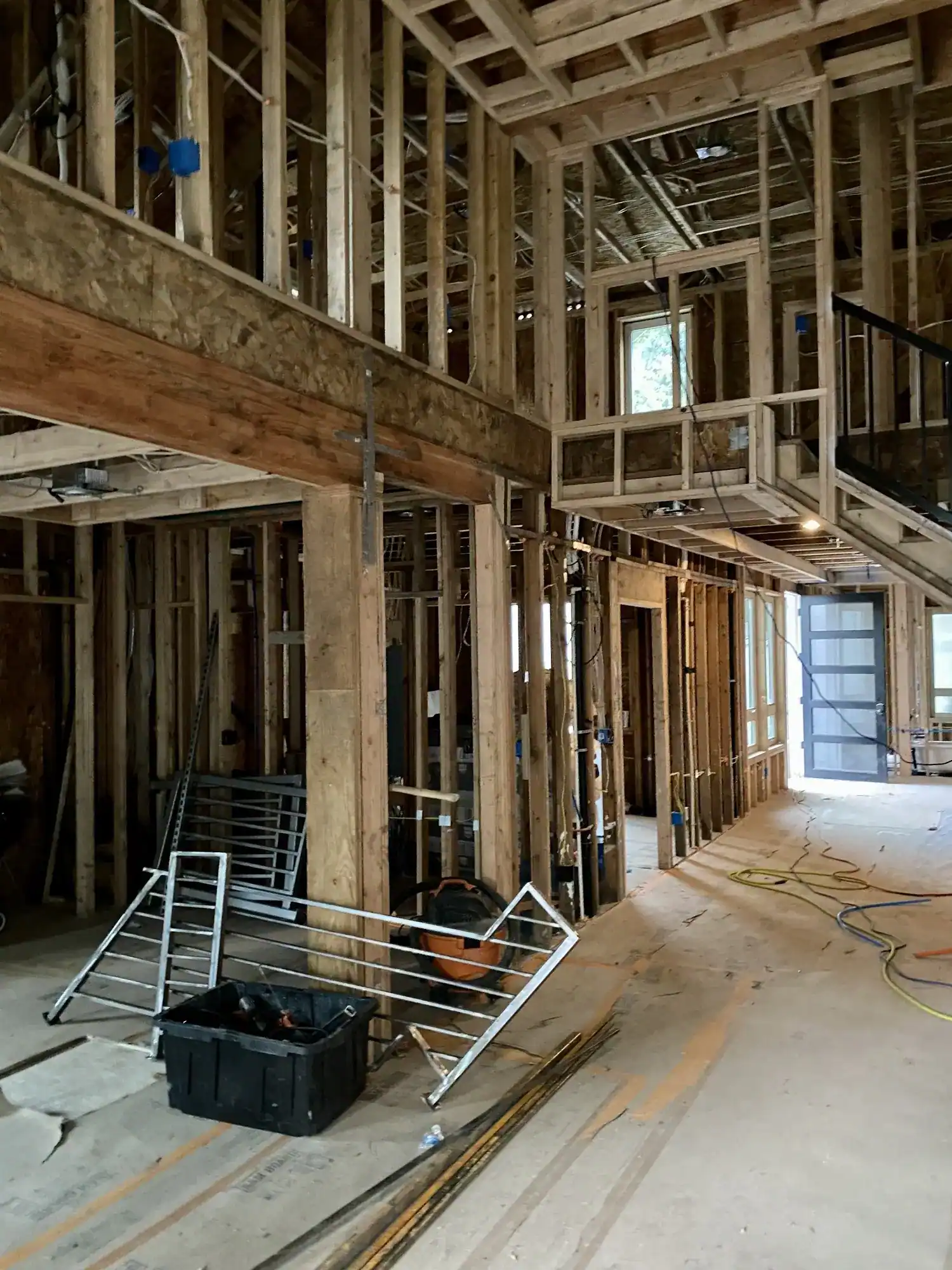 Wall framing at the stairwell with new windows set in the rough openings