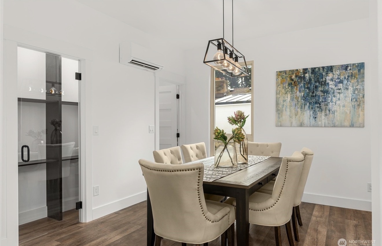 Dining area with a chandelier, abstract artwork, and a built-in wine fridge