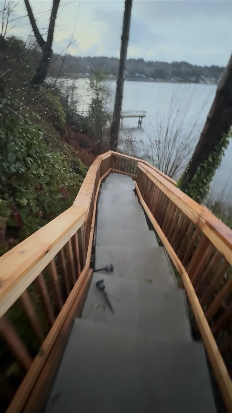 Looking down the finished stair between cedar rails toward the beach