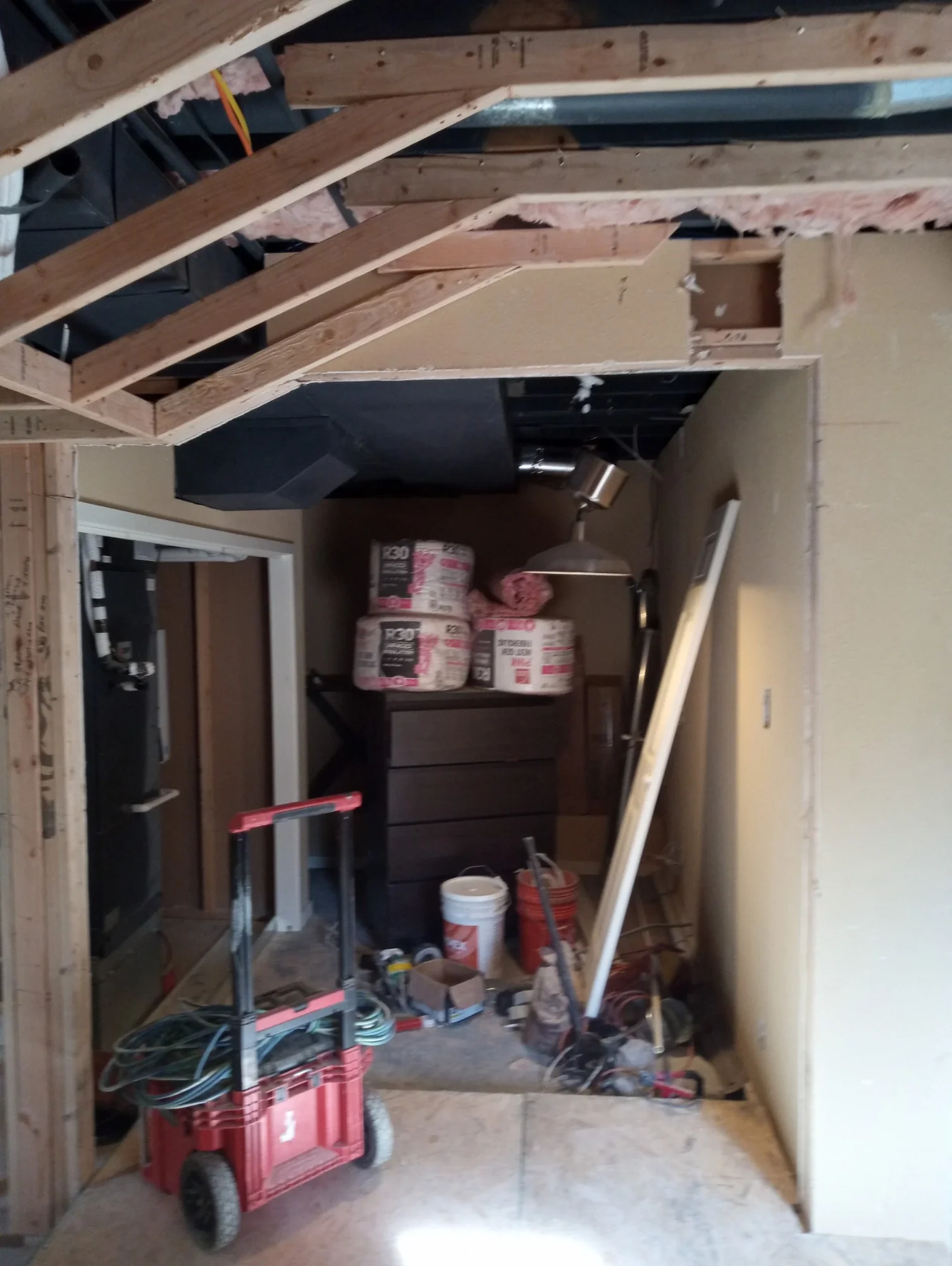 Ceiling soffit framing above the theater doorway with tools and materials staged
