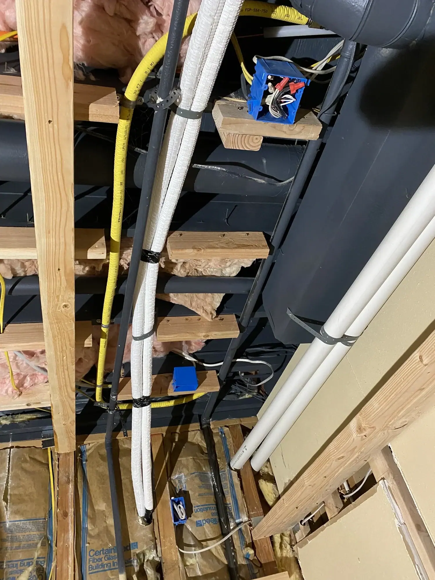 PEX plumbing and electrical routed through the joists above the theater
