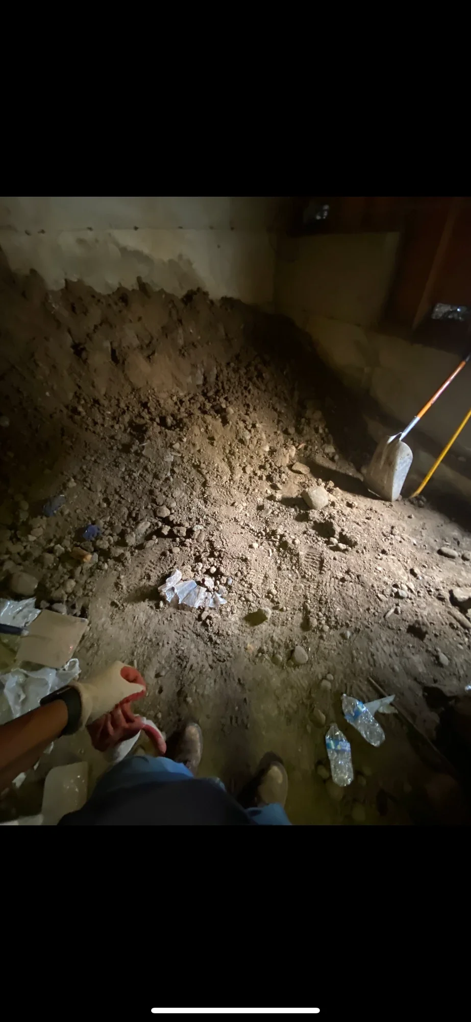 Excavated soil piled under the basement floor during the hand dig-out