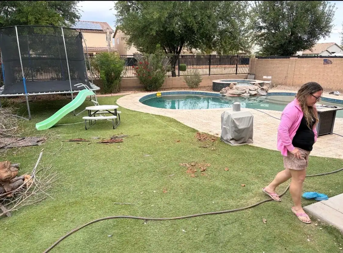 Before: patchy lawn with a trampoline and garden hose beside the existing pool