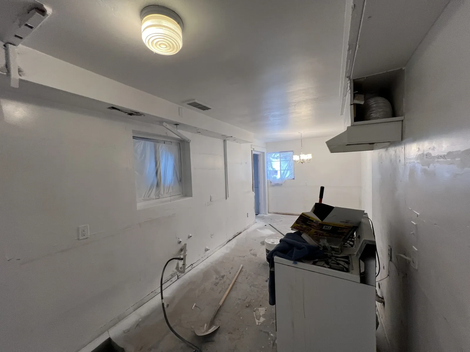 Kitchen gutted to bare walls with old finishes removed