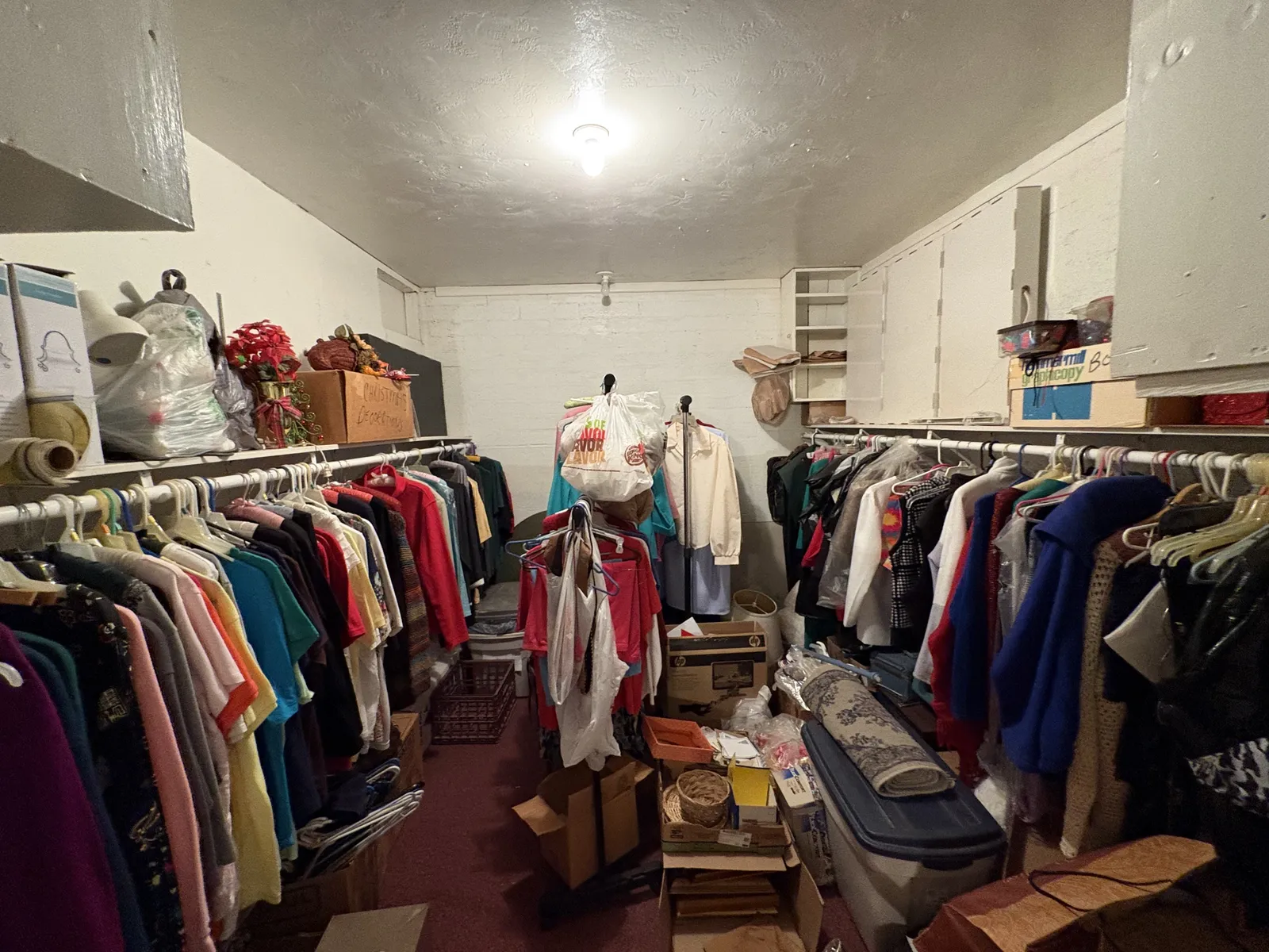 Before: a room filled floor to ceiling with clothing racks