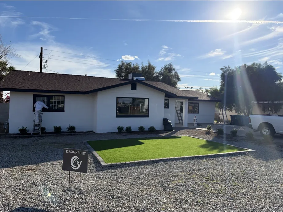 Repainted front exterior with new turf, gravel beds, and the brown roof