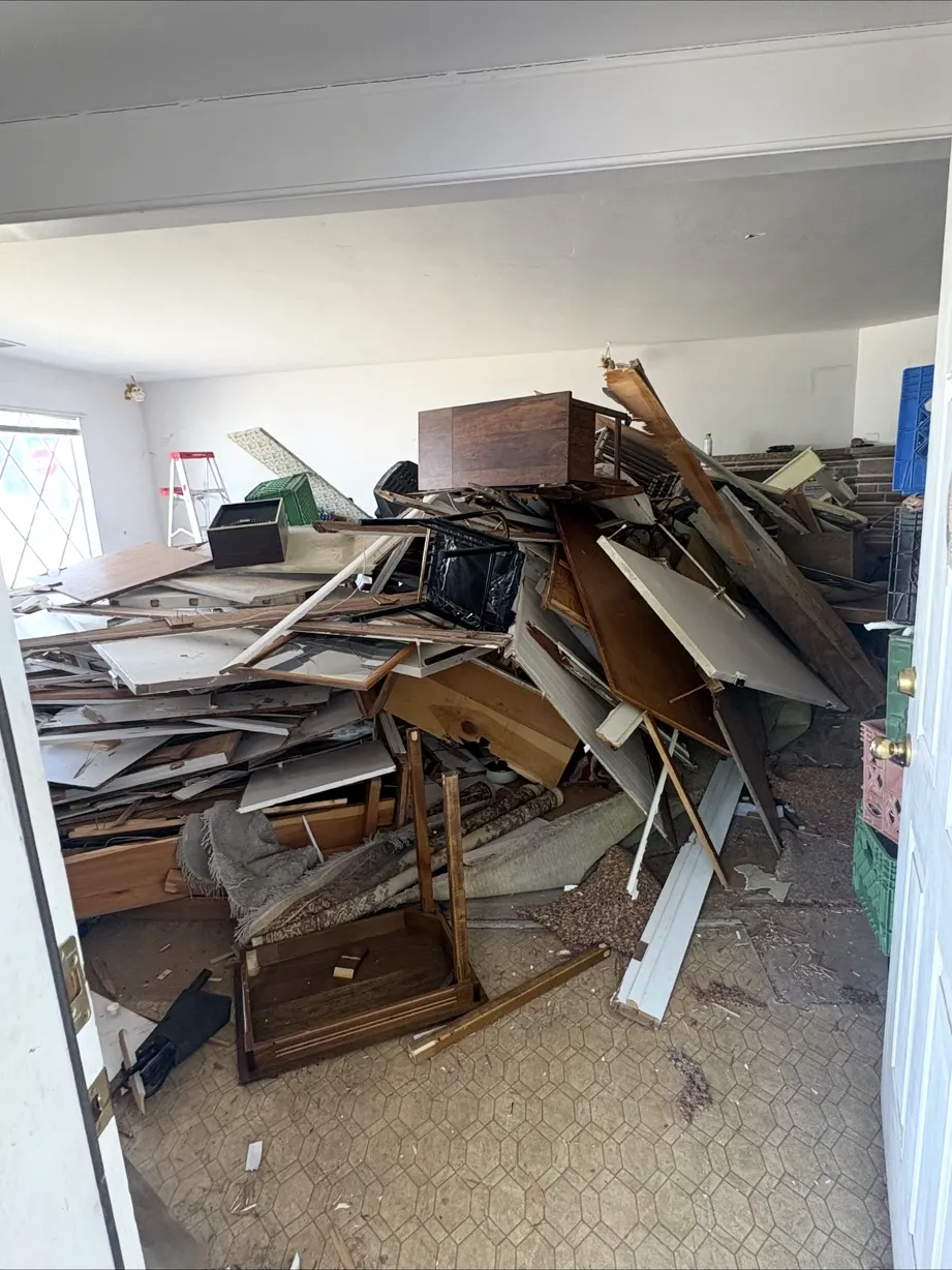 Room piled with demolition debris and old cabinetry