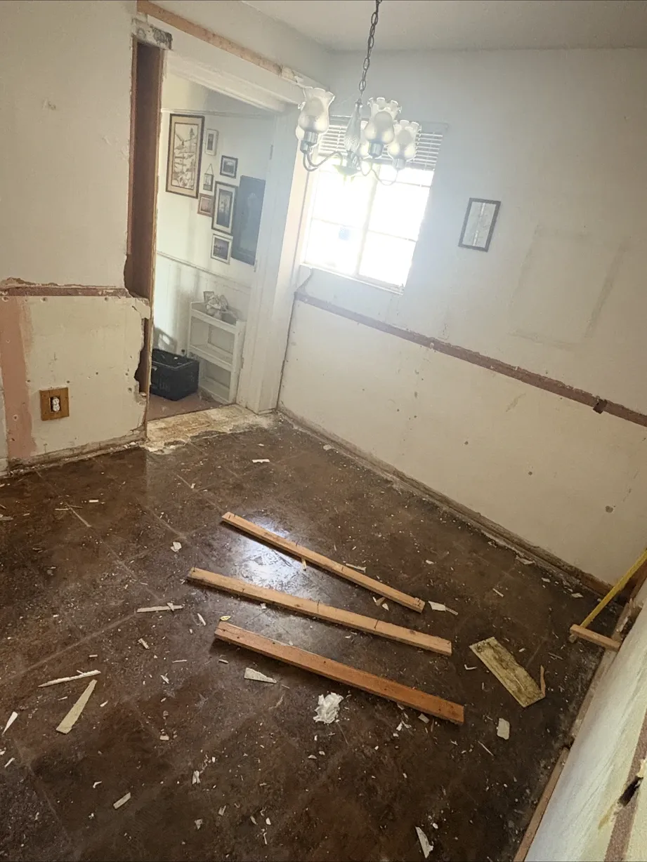 Old kitchen with cabinets removed and walls stripped