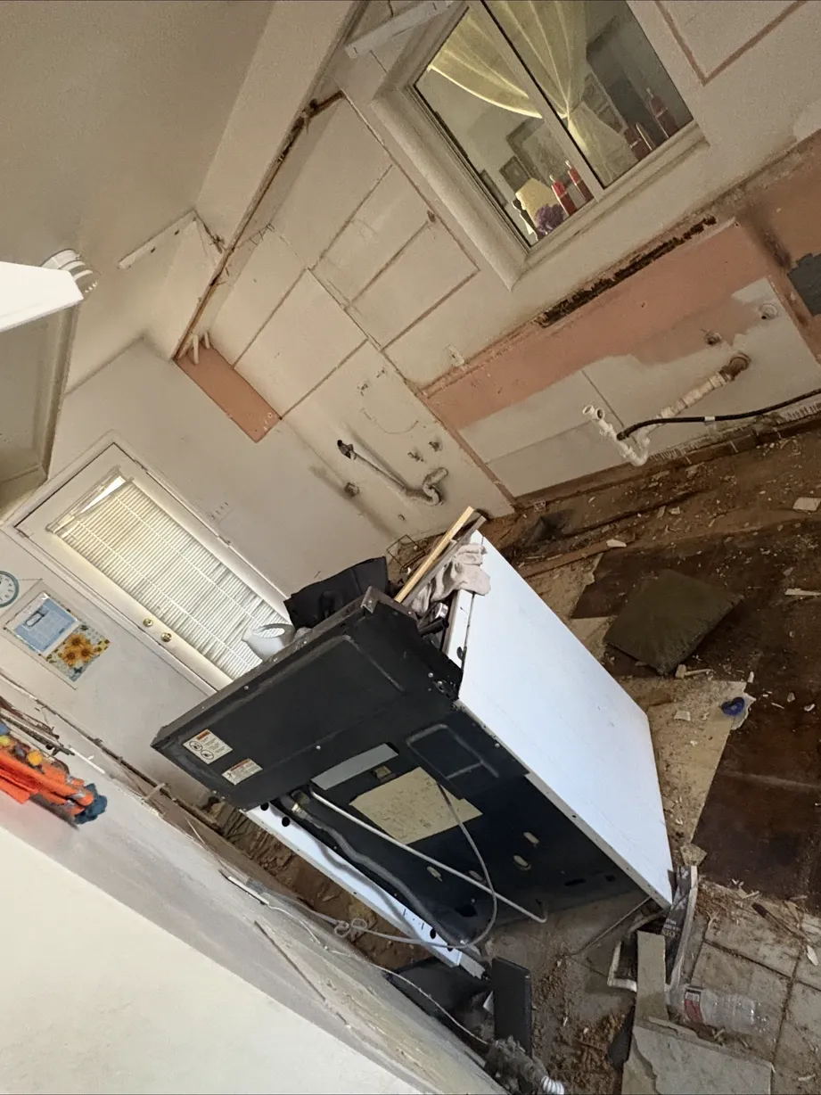 Old kitchen cabinets torn out and piled for haul-off