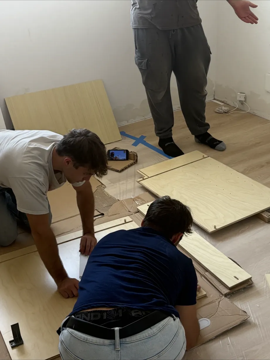 Crew installing wide-plank flooring during the remodel